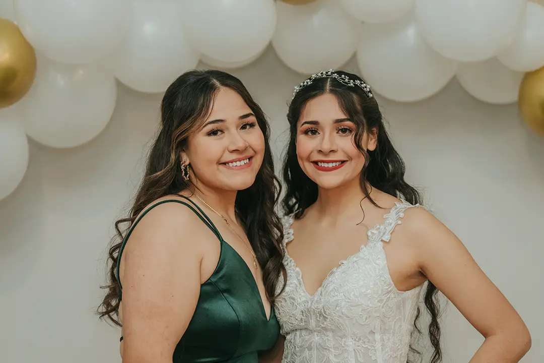 Sister and bride posing for photo